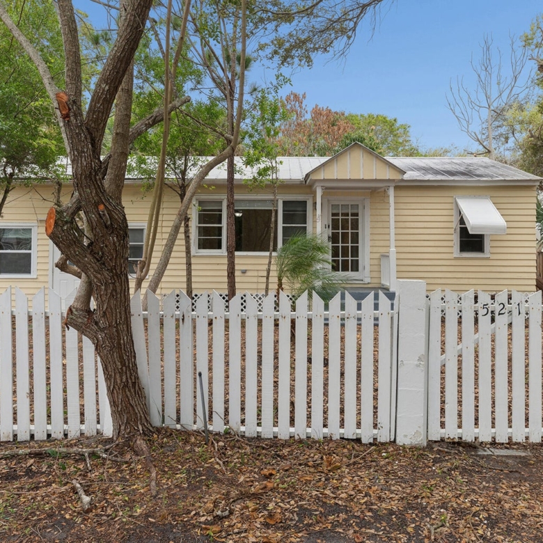 521 SW Halpatiokee Street home with white picket fence