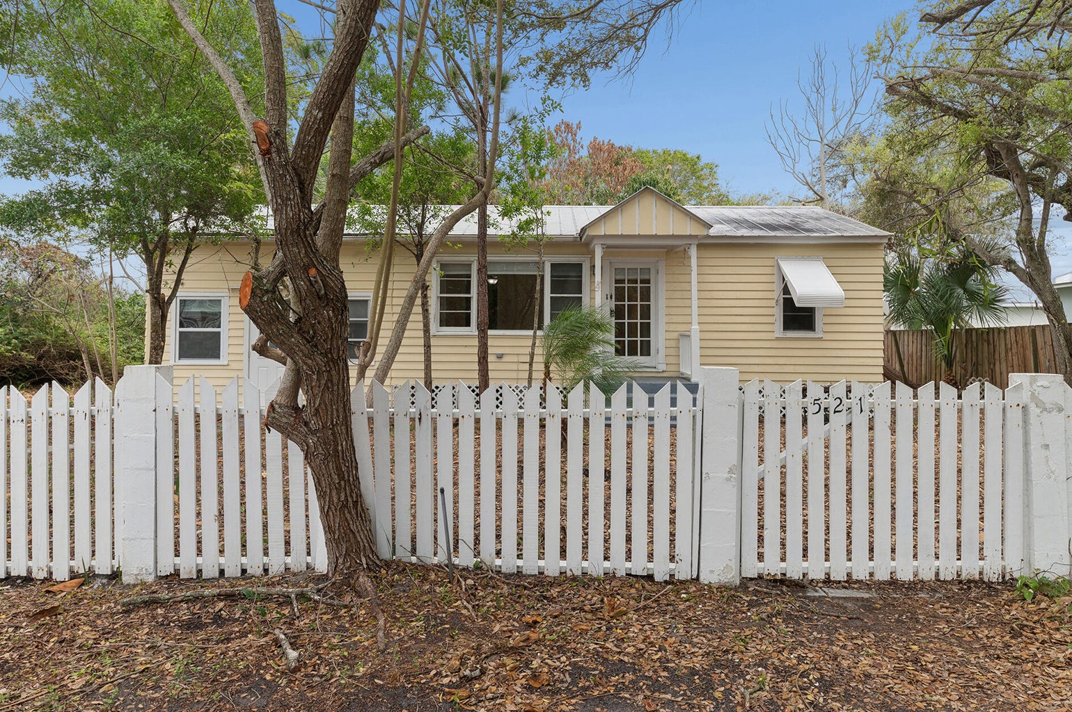 521 SW Halpatiokee Street home with white picket fence